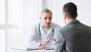 senior doctor consults young patient