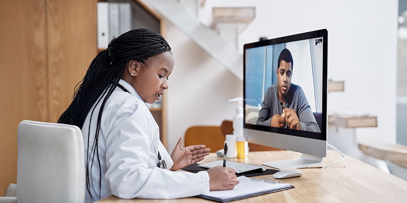 Doctor and patient engaged in a face-to-face clinical conversation