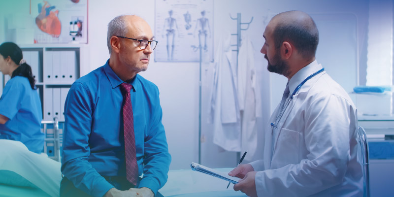 doctor discussing treatment options for male breast cancer patient 
