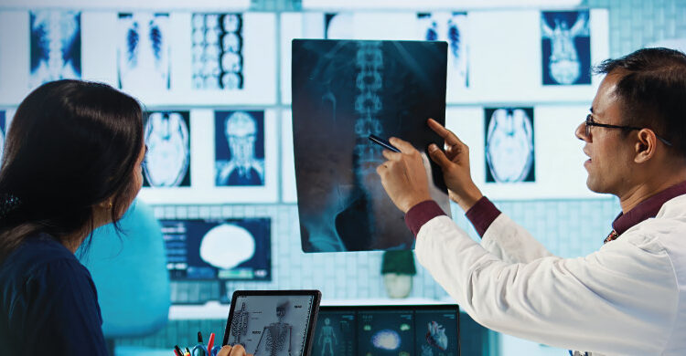 osteosarcoma treatment consultation showing doctor reviewing bone scan with patient