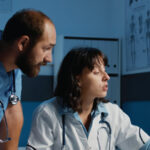 healthcare professional working on laptop exploring side hustles for healthcare professionals