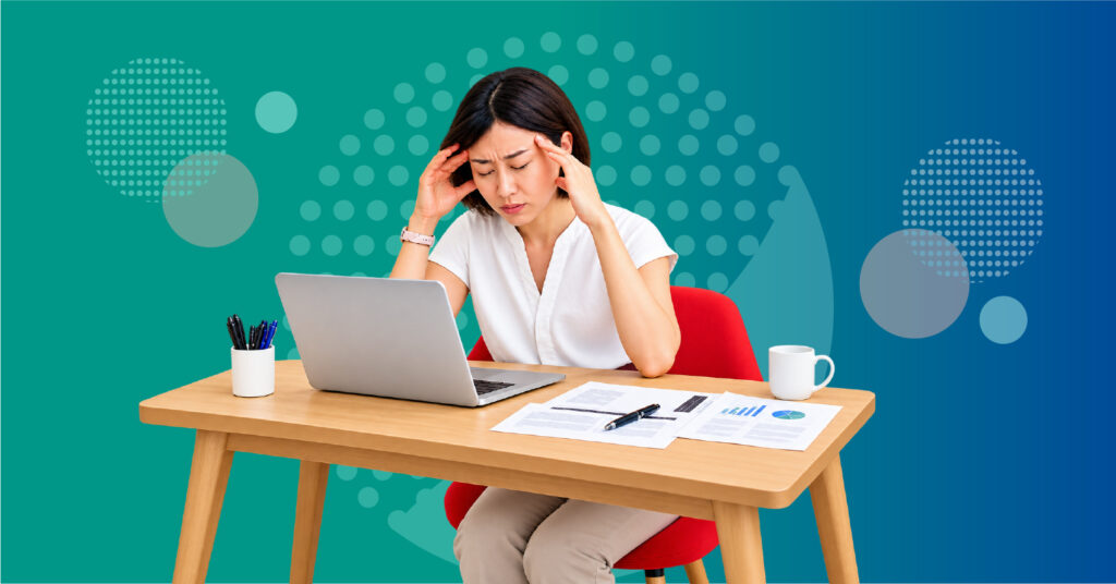 professional managing migraine symptoms while working at a computer with screen light workplace noise and other sensory demands